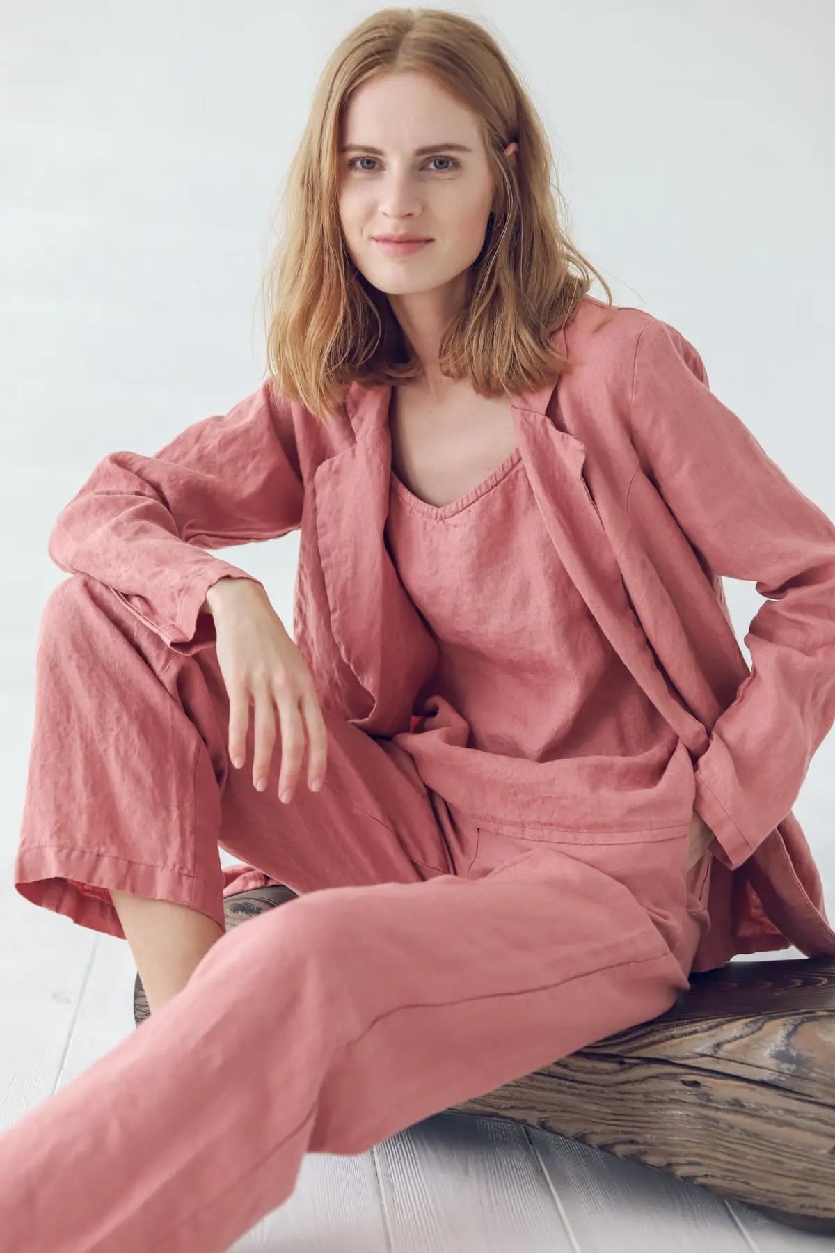 Chic linen jacket styling while sitting in a casual pose