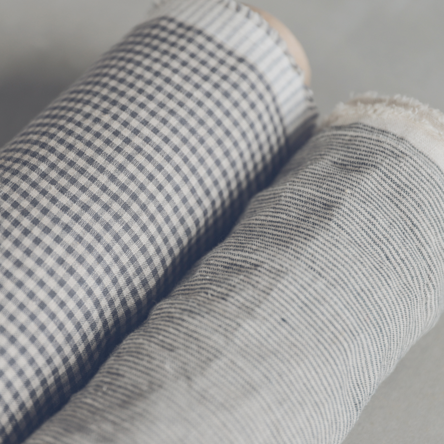 Two rolls of patterned linen fabric.