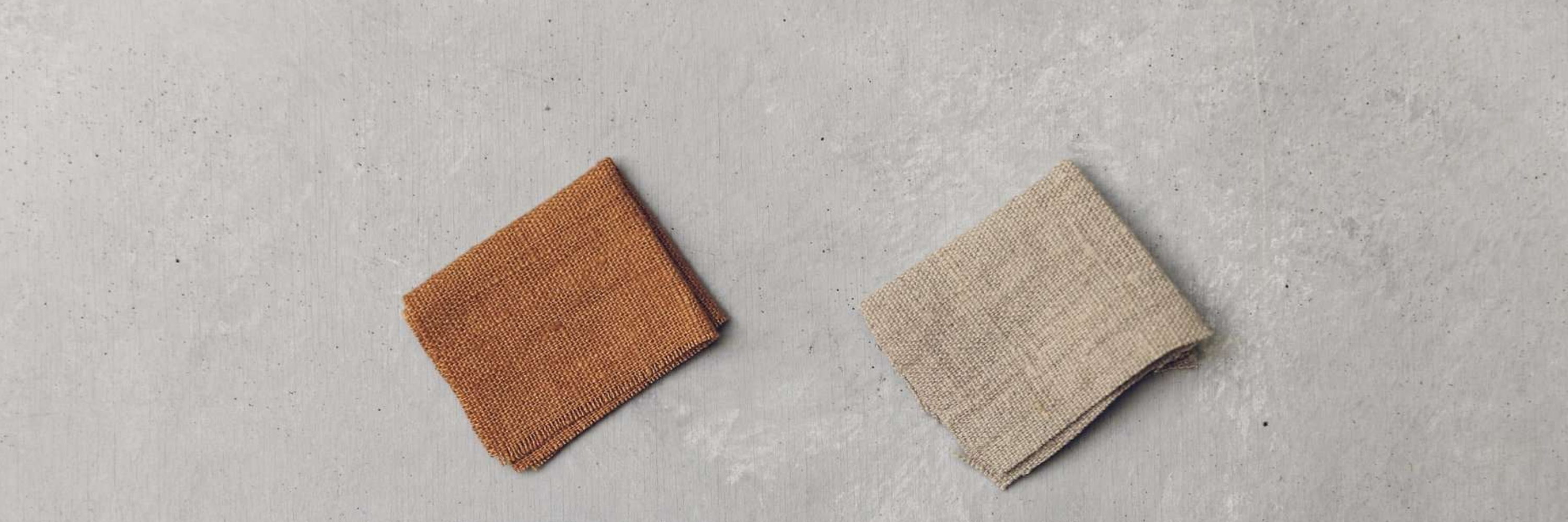Two folded pieces of heavy linen fabric.