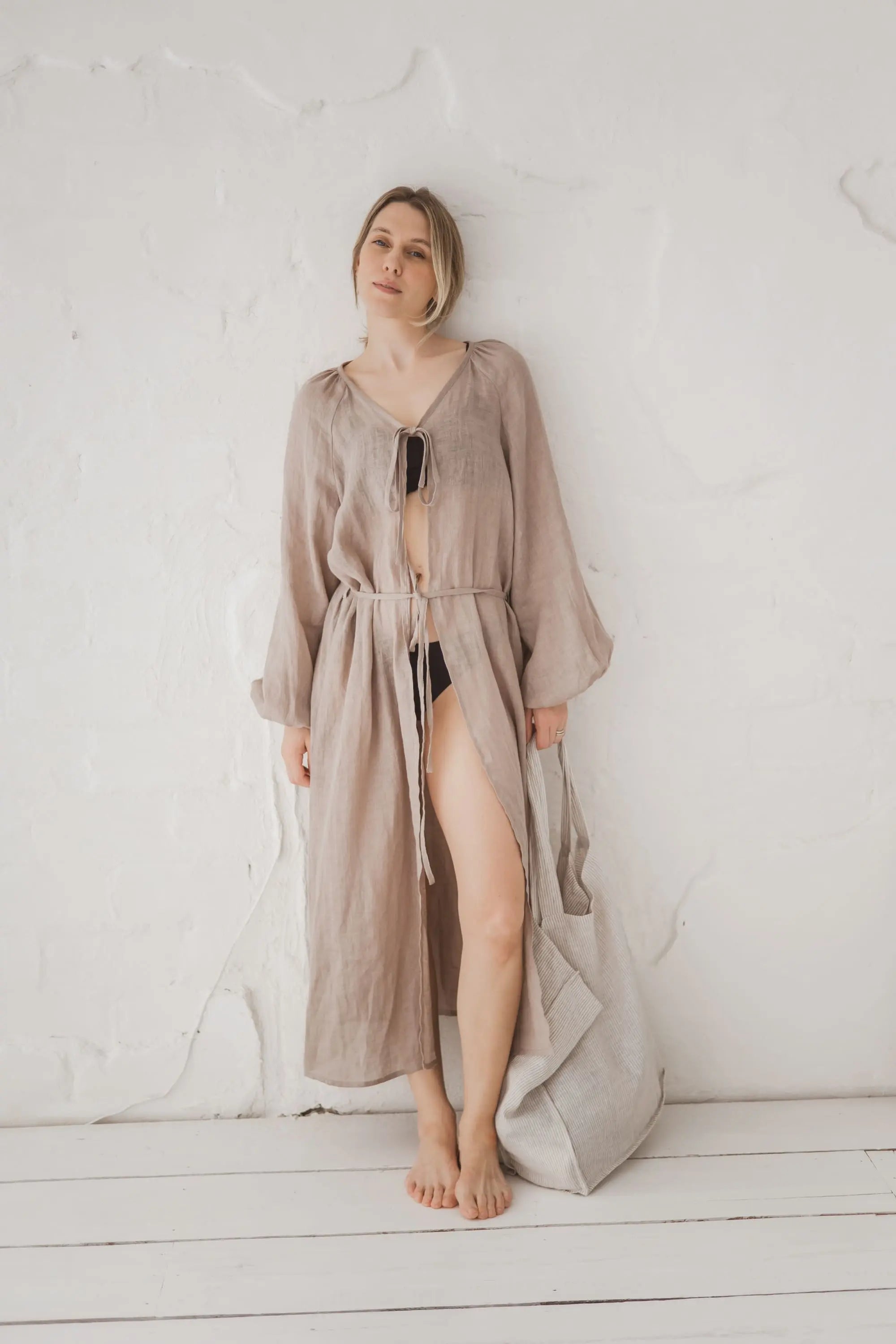 Woman in a natural linen kaftan open at the front, full length front view