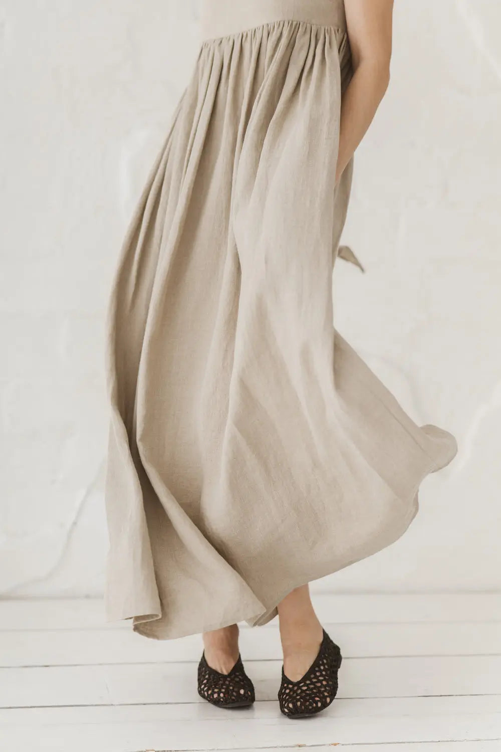 Flowing linen maxi dress, front view from waist down