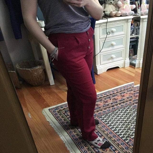 A customer wearing Epic Linen's tapered Oslo pants in the dark cherry red color.