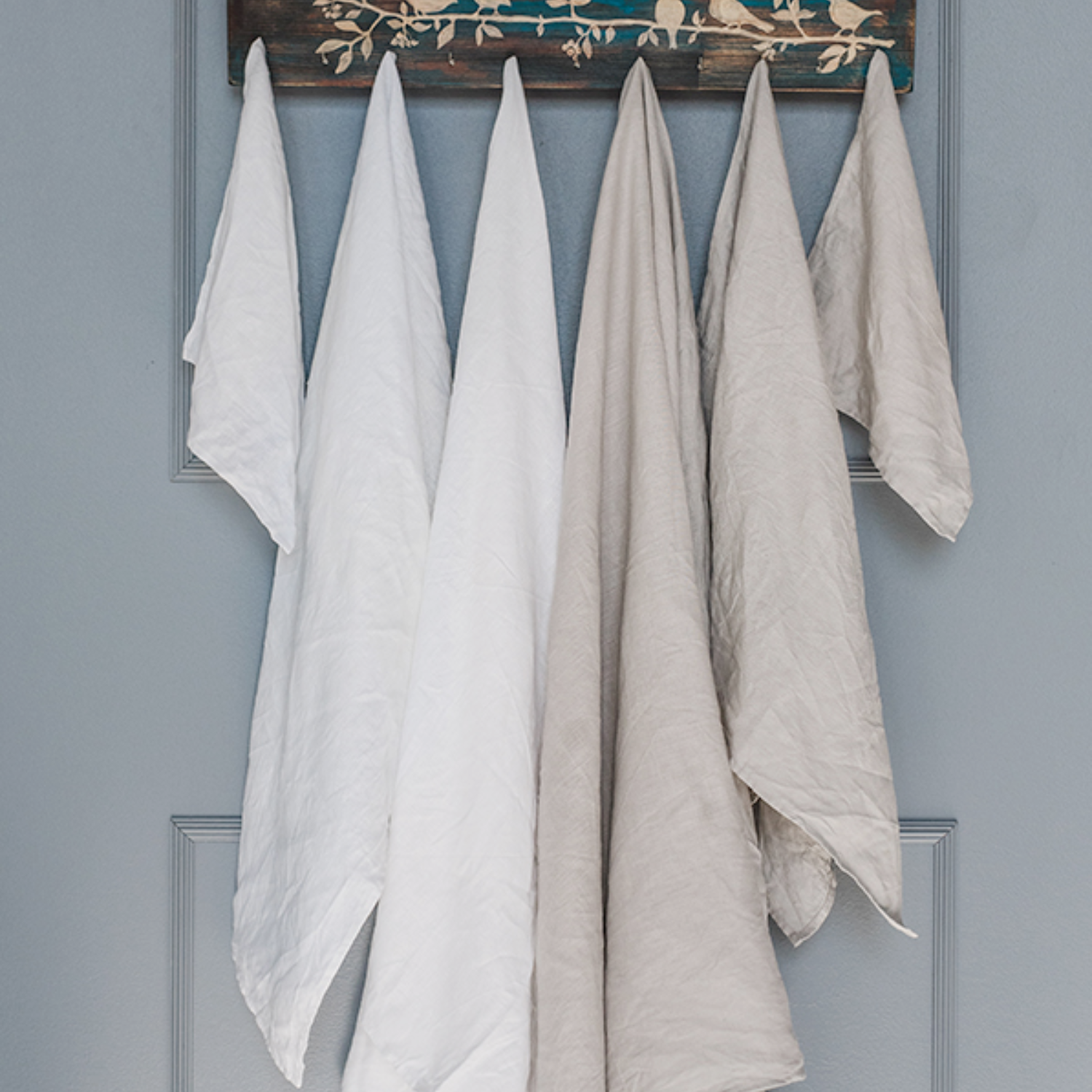 Hanging pure linen bath towels in white and natural colors.