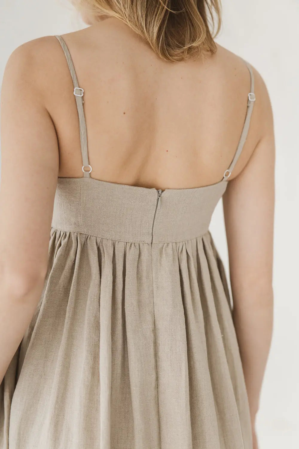 Back detail of linen maxi dress showing hidden zip and adjustable spaghetti straps