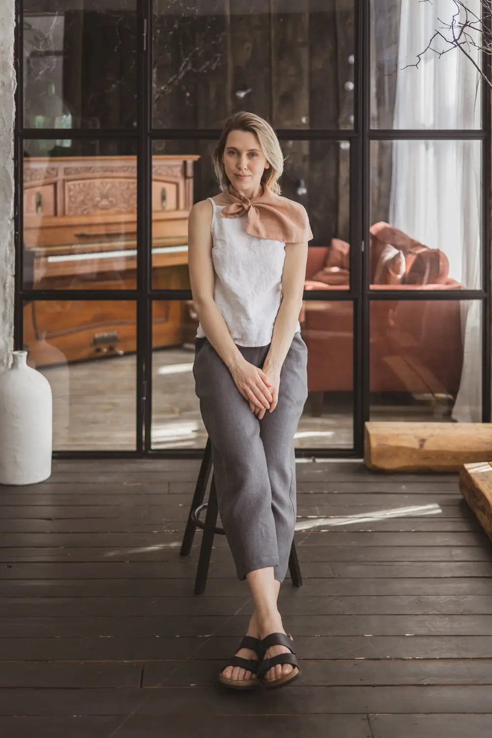 Full outfit view of a woman wearing a light peach linen loop scarf
