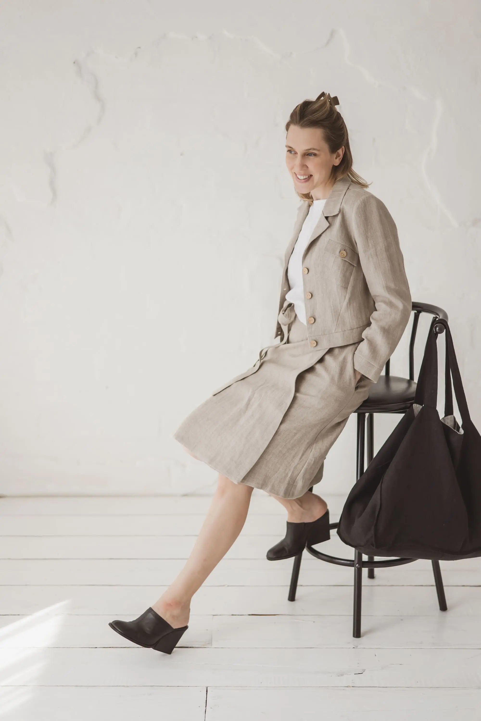 Structured Cropped Linen Blazer — side view with linen skirt and black tote bag