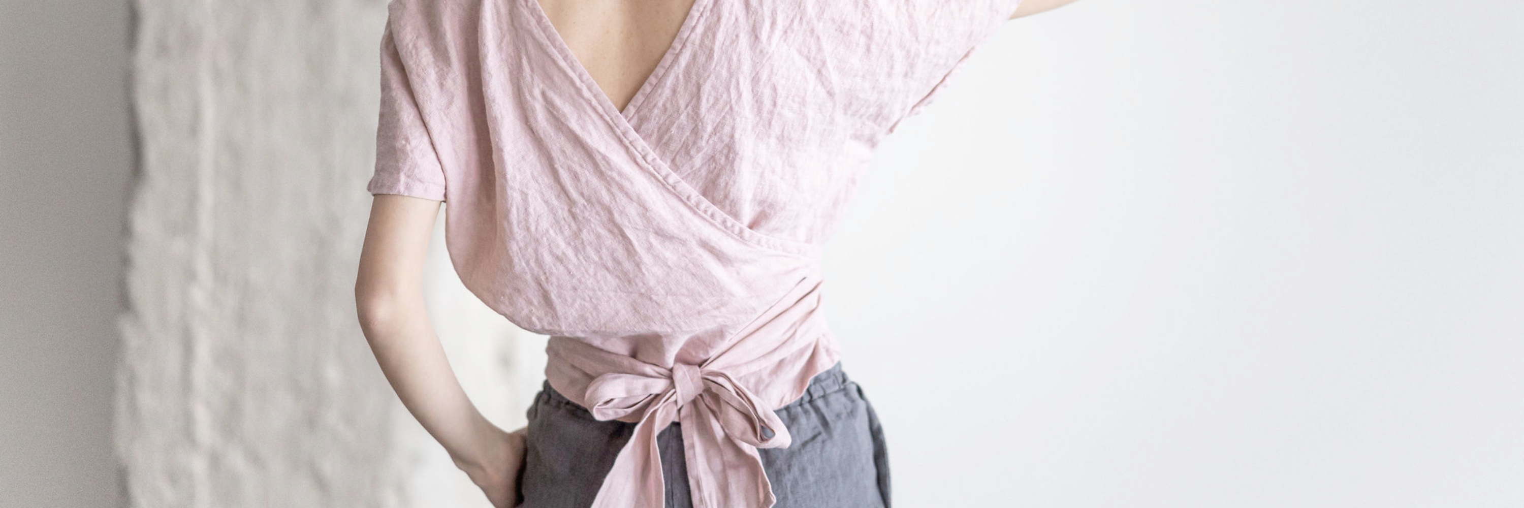 A woman from the back, wearing a linen wrap top.